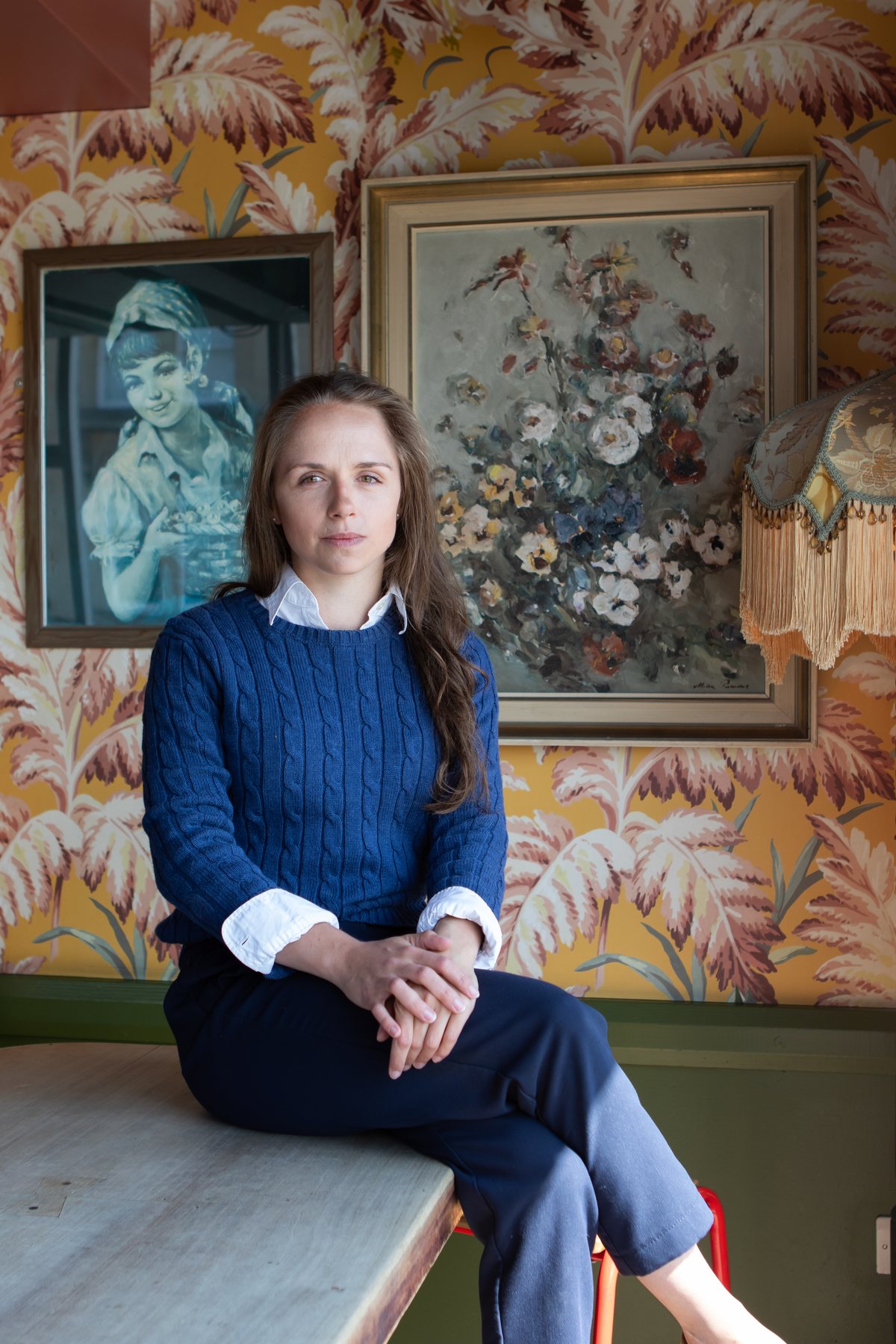 Ellie, founder and coach at Feral Growth, seated and looking at the camera